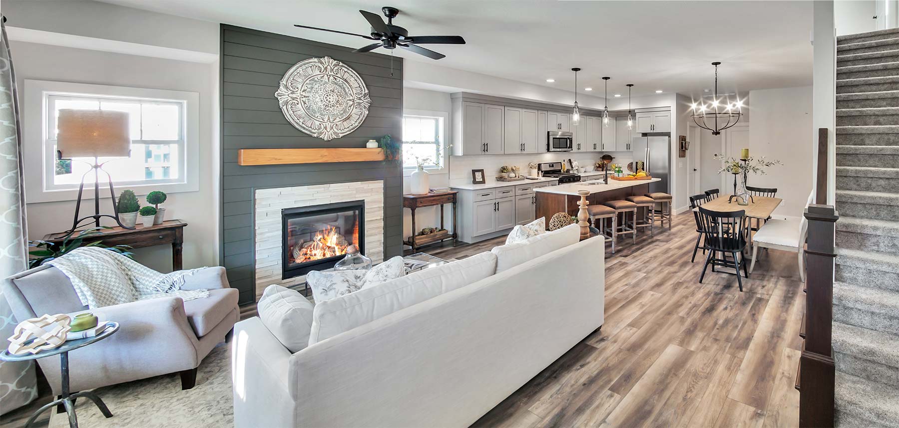 panoramic view of the living room with fireplace and kitchen in a new construction home in Gateway Grove, Warsaw, Indiana
