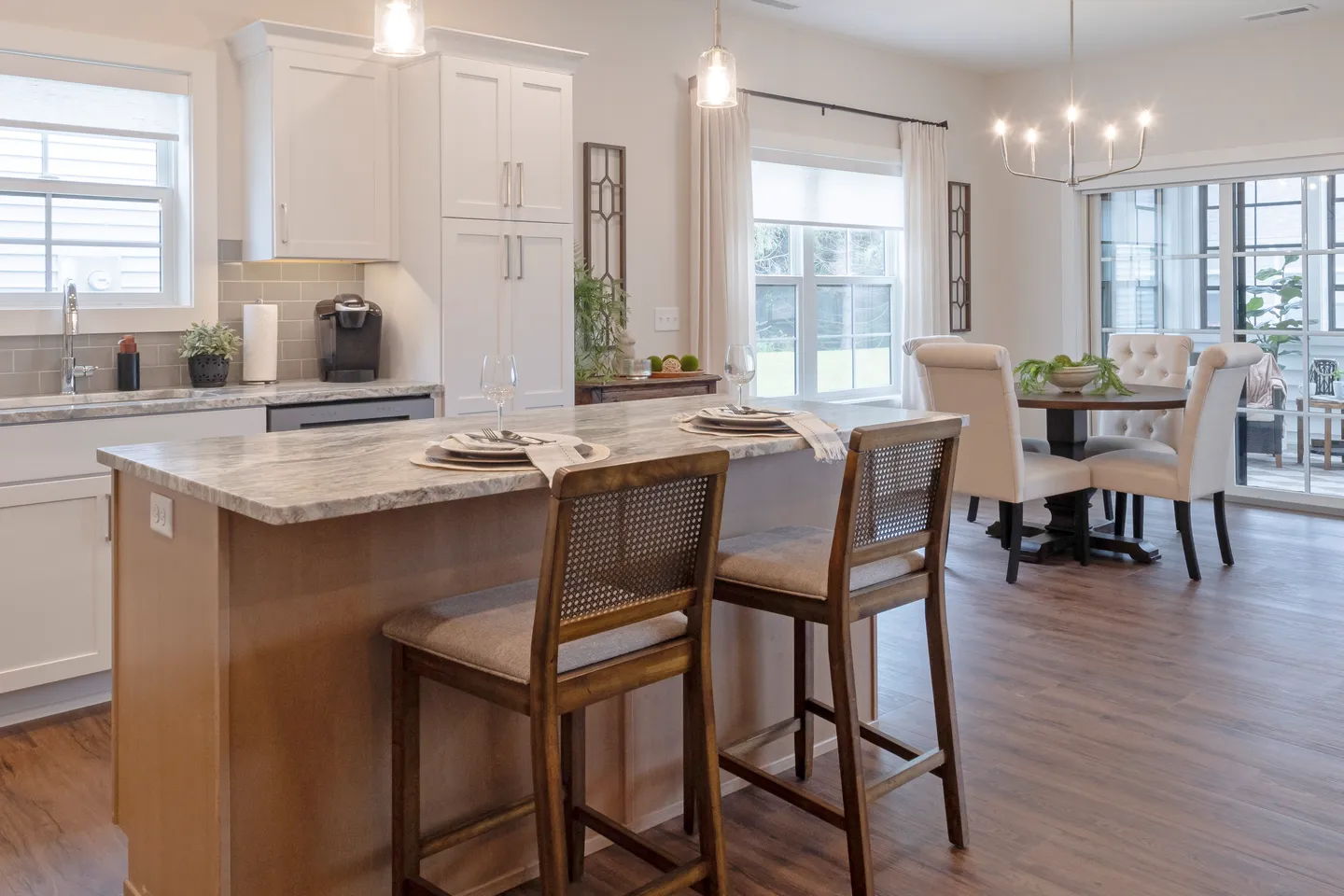 Kitchen island and dining area in a senior living development home built by T.L. Jackson in Syracuse, Indiana.