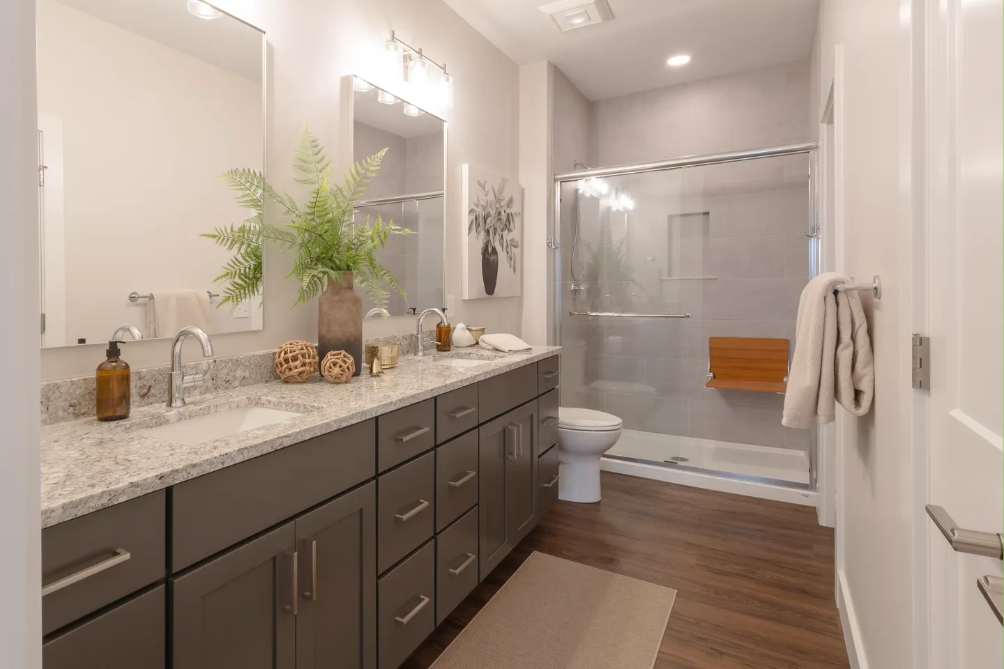 Accessible primary bathroom with walk-in shower and fold-down seat in a T.L. Jackson senior living home in Syracuse, Indiana.