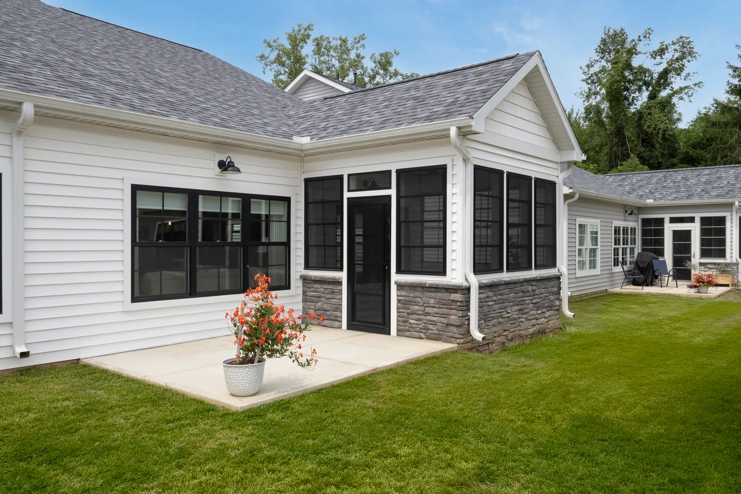 Single-level duplex home with enclosed porch and patio at Rabbit Ridge Senior Living in Syracuse, Indiana.