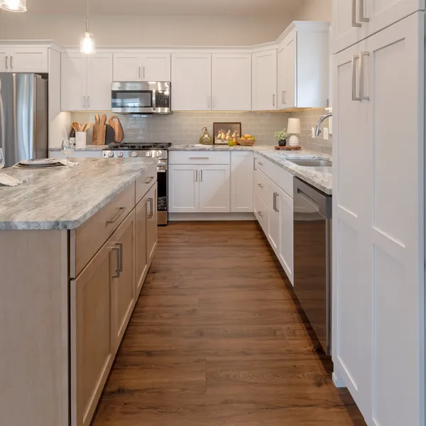 Wide, accessible kitchen walkway designed for aging in place at Rabbit Ridge senior housing in Syracuse, Indiana.
